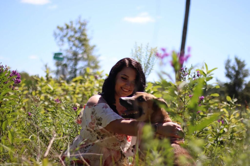 Woman in a field with her dog